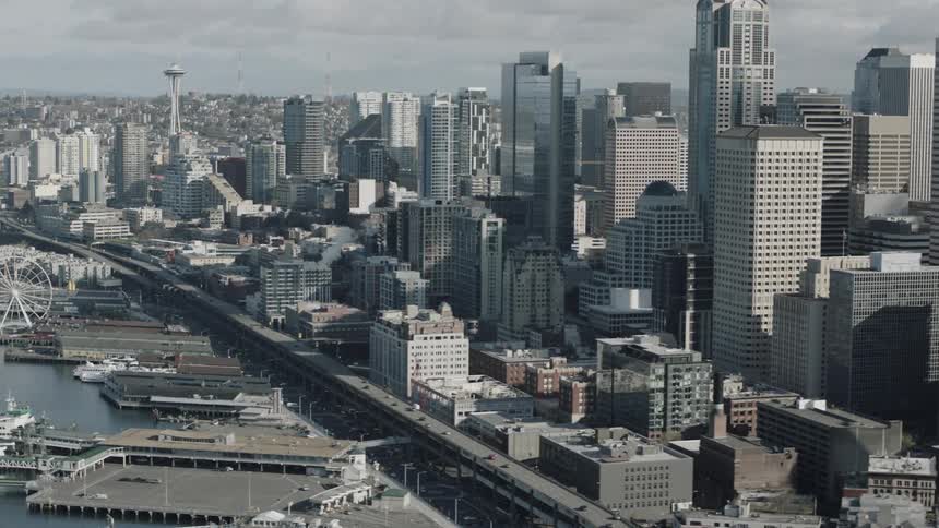 Cars travel on a freeway along seattle's harbor