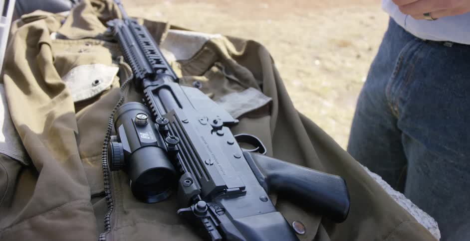Rifle with a scope lying on a table