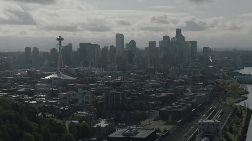 A large city near a river on a cloudy day