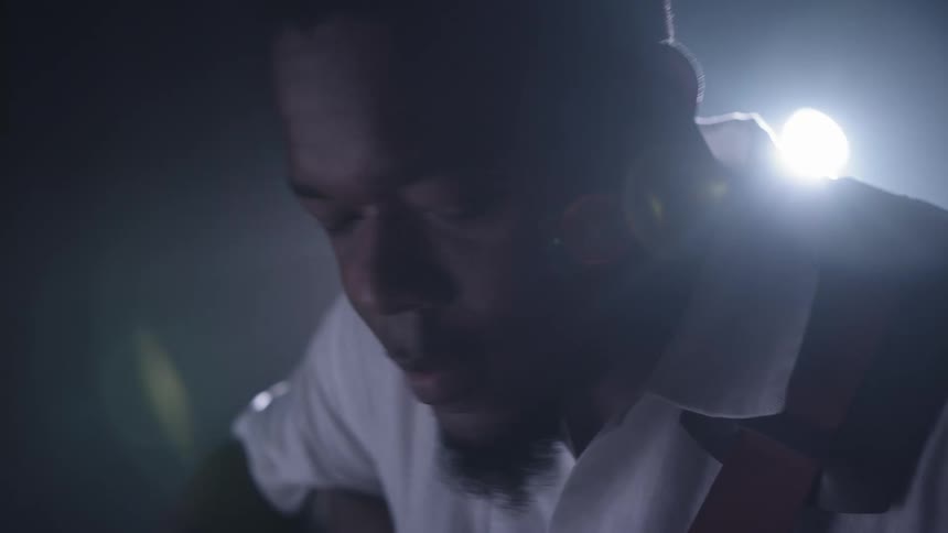 A man plays guitar and sings