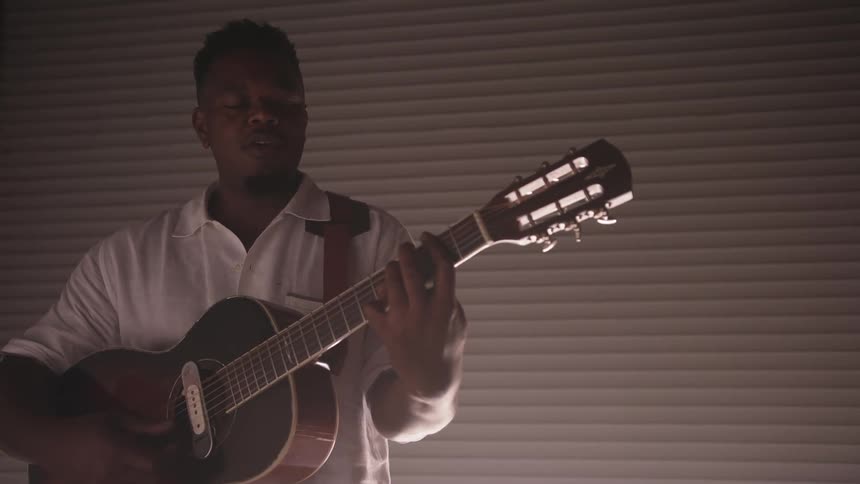 A man plays guitar
