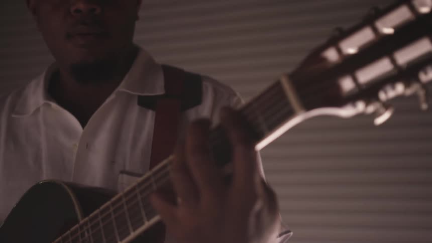 A man singing and playing a guitar