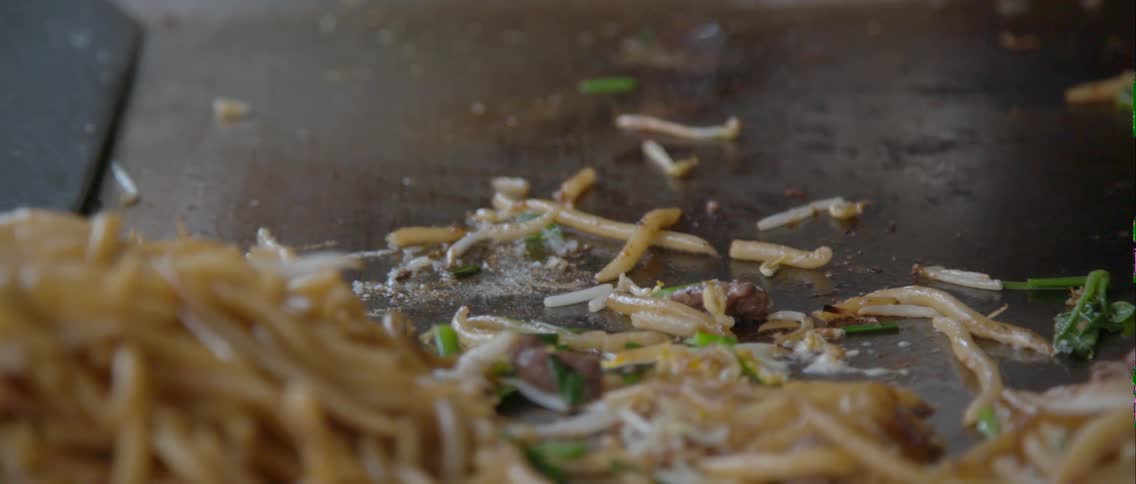 Food is cooking on a flat stove