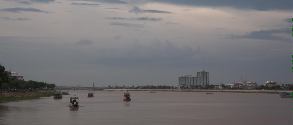 People sail in boats near the shore