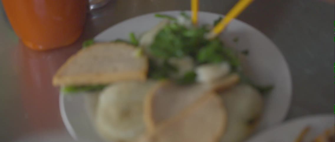 Person stirring food with chopsticks