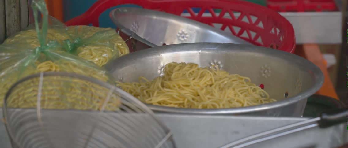 Cooked spaghetti noodles in large metal bowl