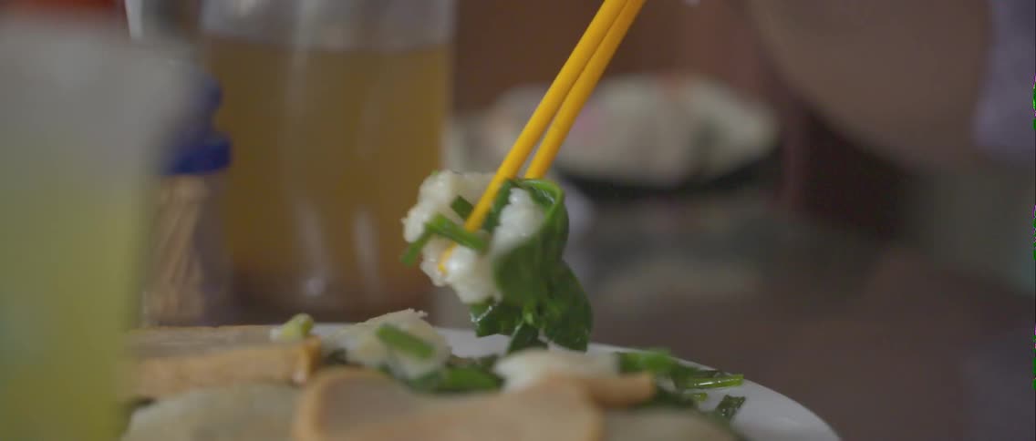 A person is eating with chopsticks