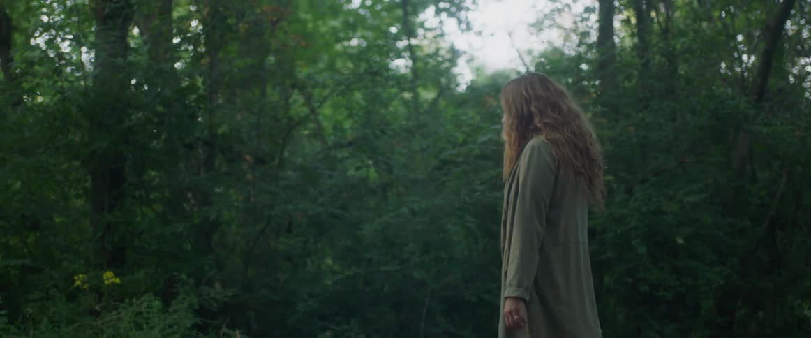 Woman walks through the forest