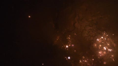 Balls of light sparking and floating up from water