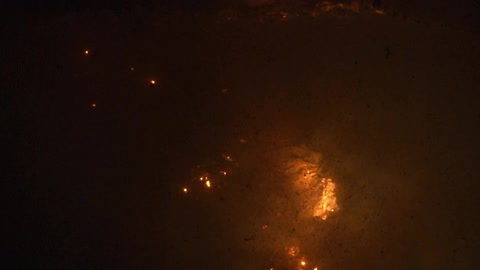 Brown white and gray colors that look like fire burning underwater with smoke and bubbles