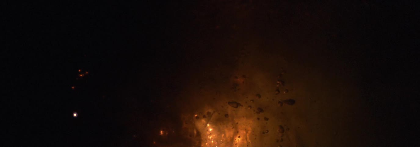 An extreme close up of bubbles and exploding light sources