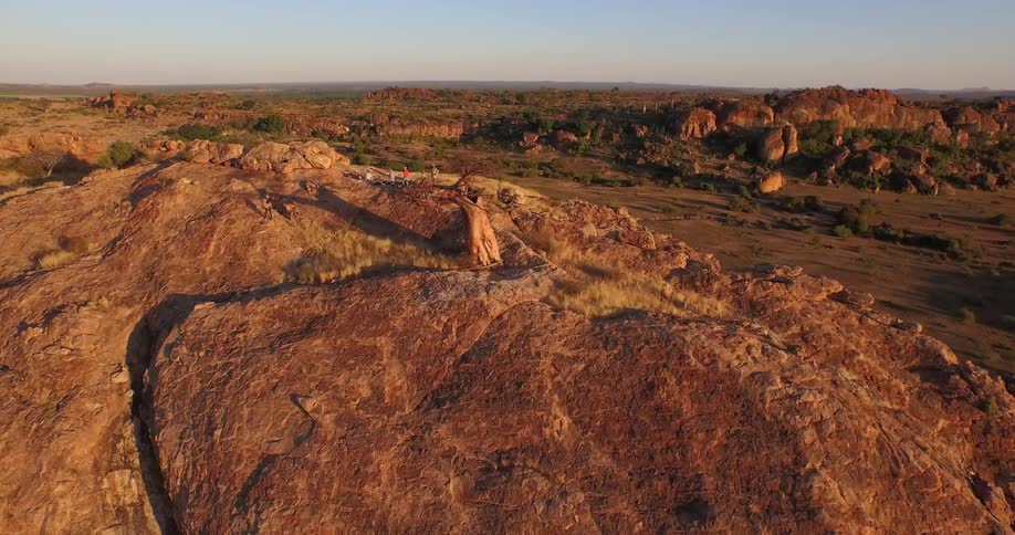Several people standing on top of a large mountain bluff