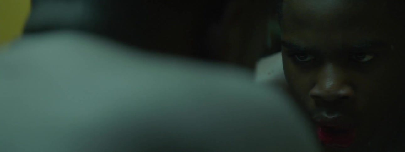 Close up over the shoulder of a man looking in a mirror