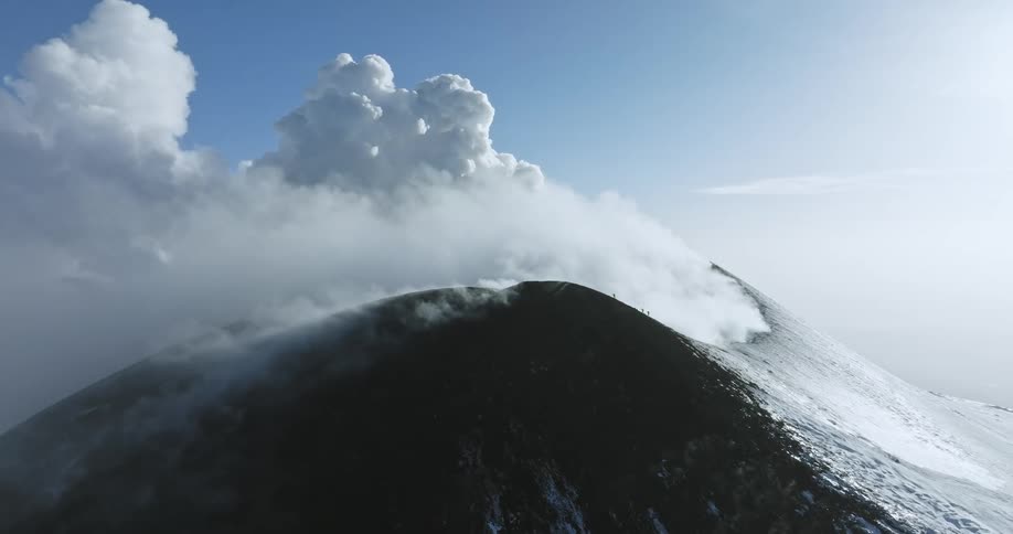 A large volcano is releasing an enormous plume of steam