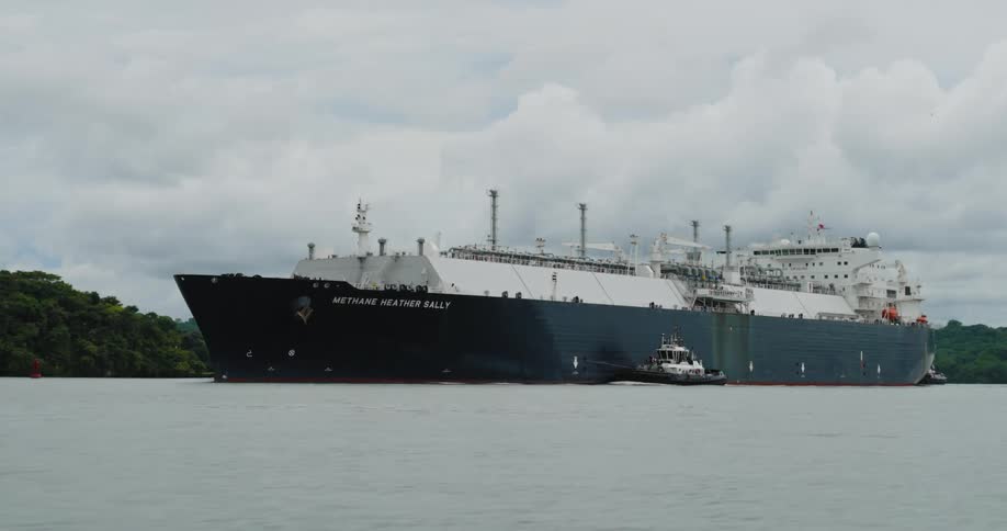 A ship is driving on ocean water during spring