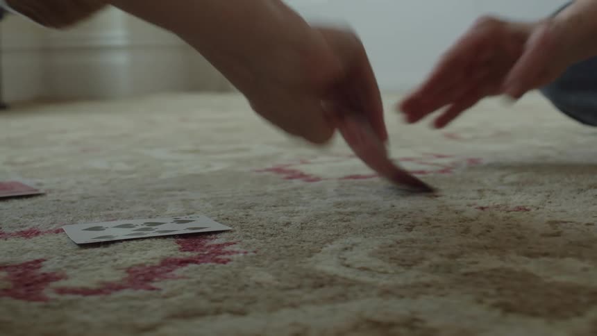 Two people are playing cards