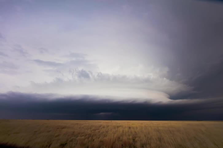 Clouds rolling over a yellow field