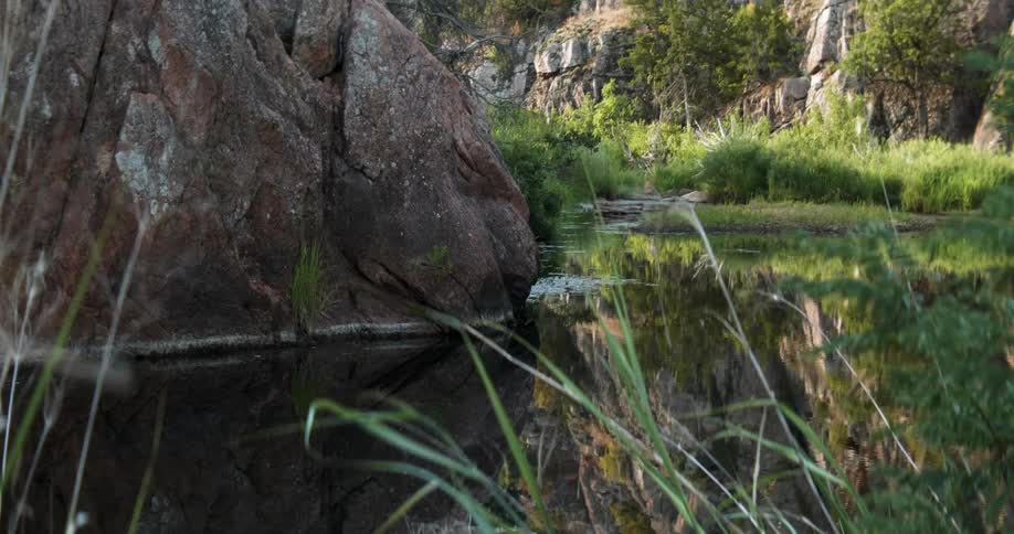 The water is calm near the rocks