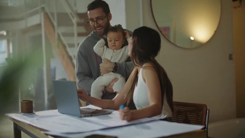 Mother and father are hanging out and holding there baby