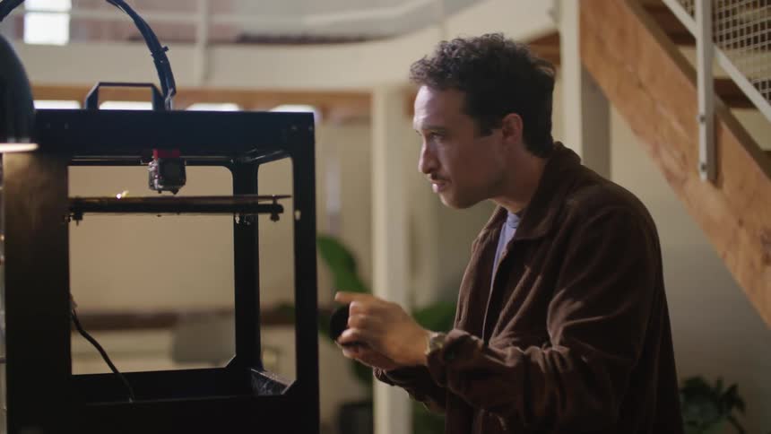 A man is fixing a machine inside of his house