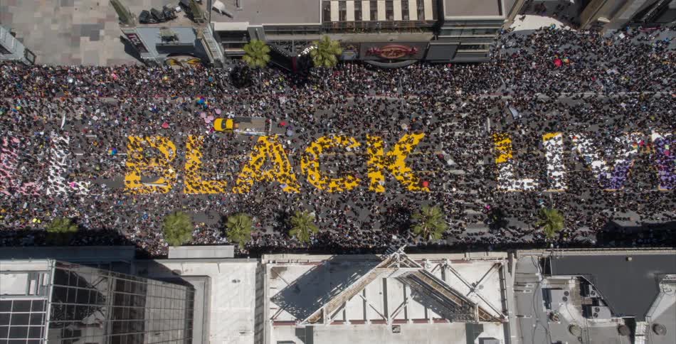 A huge crowd of people fill a downtown street during a black lives matter rally