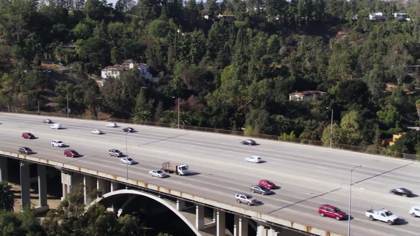 Traffic flows along both sides of controlled access highway passing through suburbs