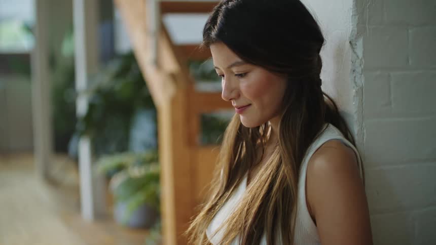 Mother is on her laptop and dad is playing with the baby