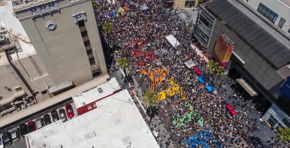 A huge crowd of people fill a downtown street during a black lives matter rally