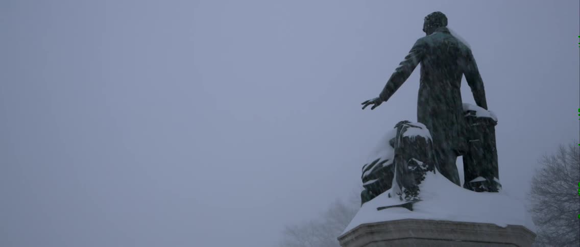 It is snowing hard on this statue
