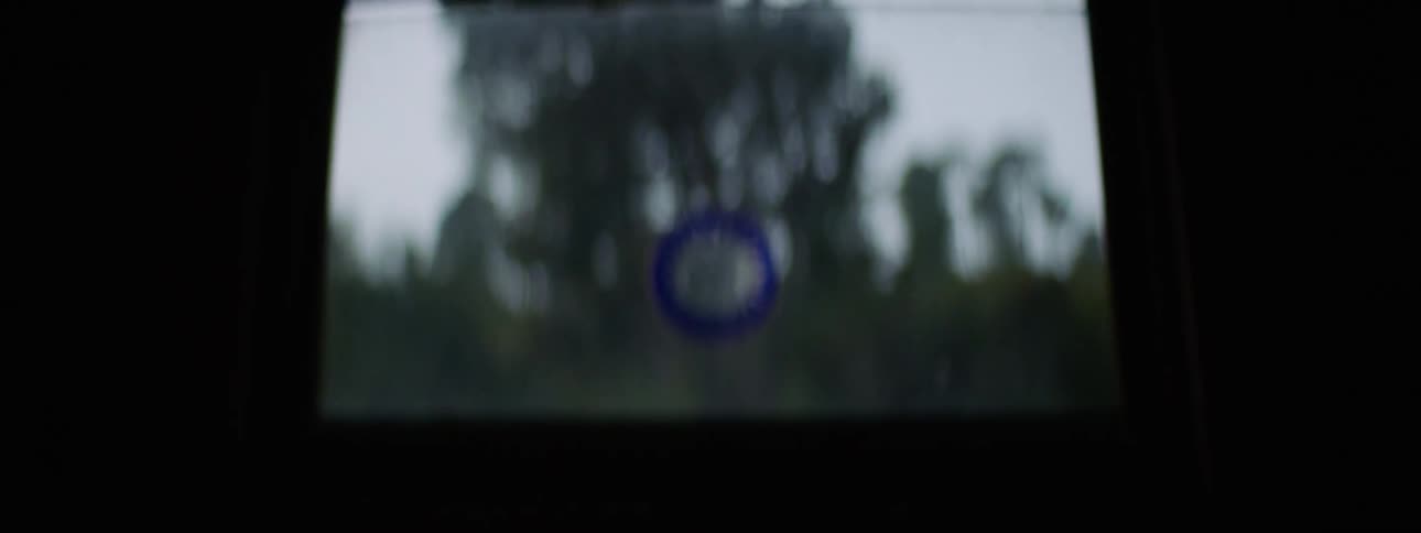 Blue sticker of a the sun and moon on the window of a dark room