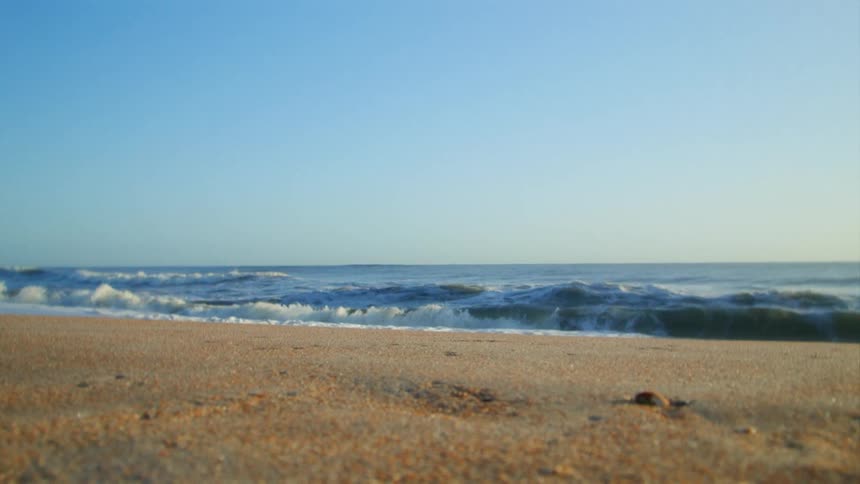 Small waves crash onto the beach