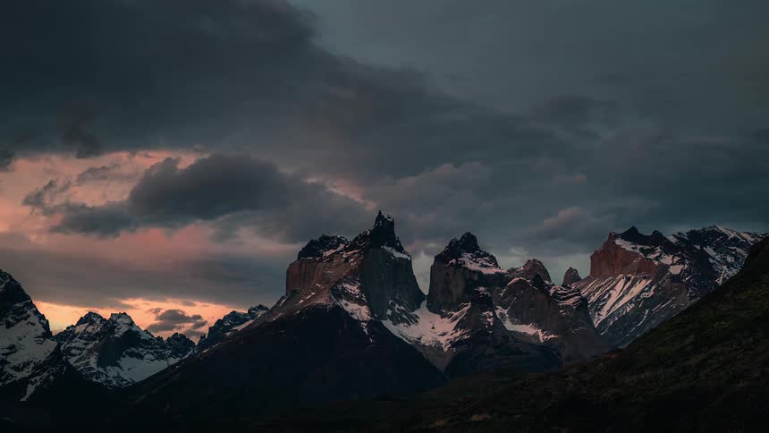 Time lapse view of the sun setting above the mountain tops
