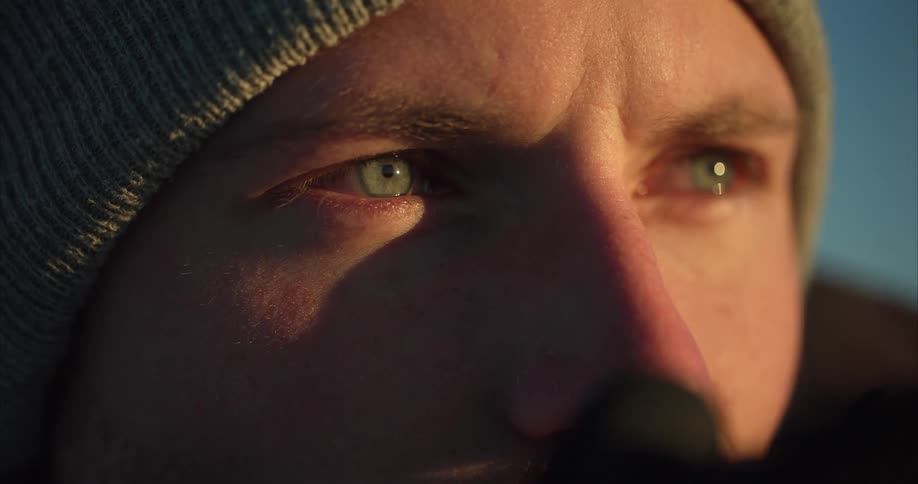 A man lowers his camera from his eyes