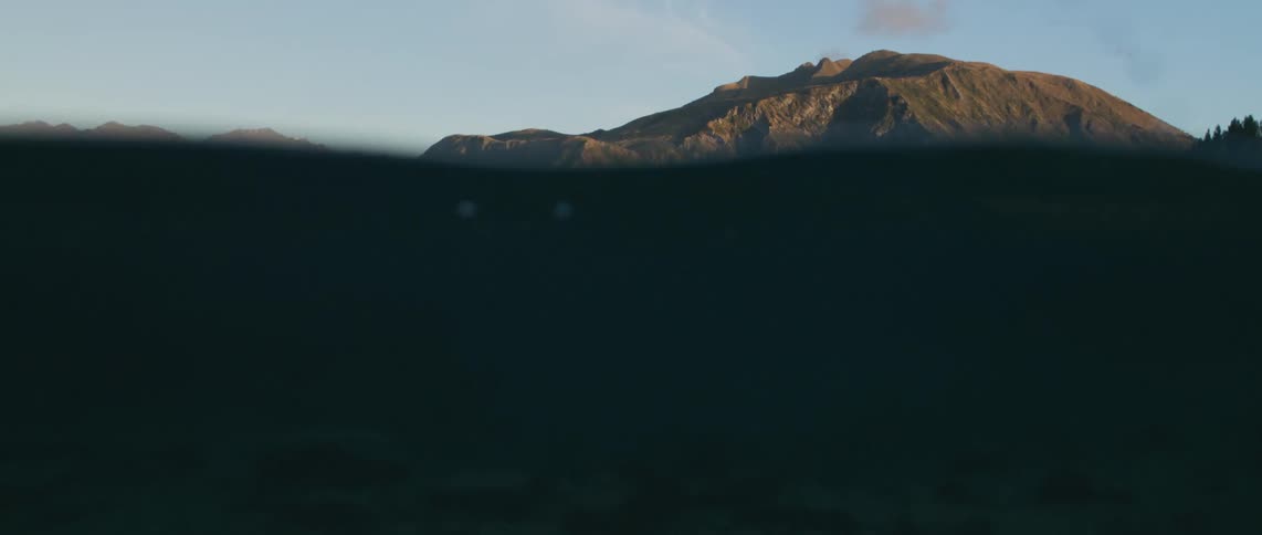 The ocean and island is displayed at dusk
