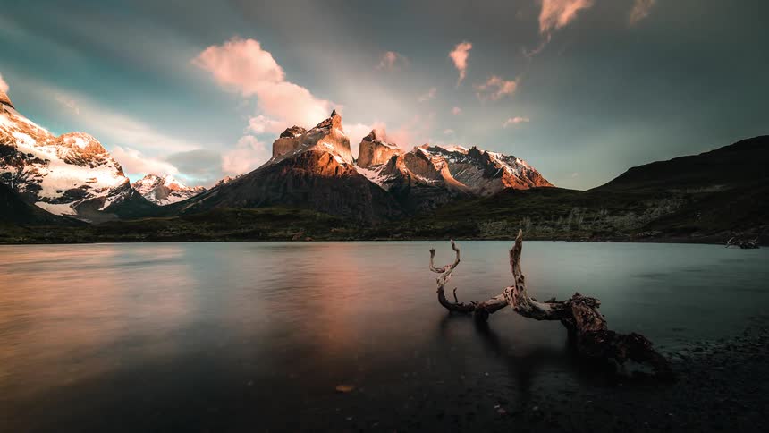 Time lapse photography of a mountain near the ocean