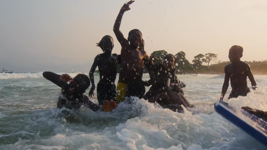 Kids are playing and swimming in the water