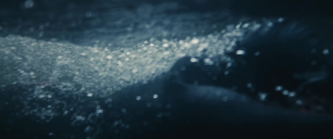 A female is swimming in a body of water
