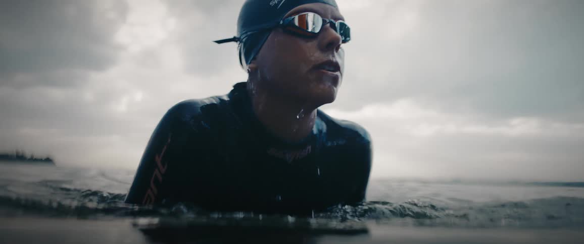 A person is swimming in the ocean water during midday