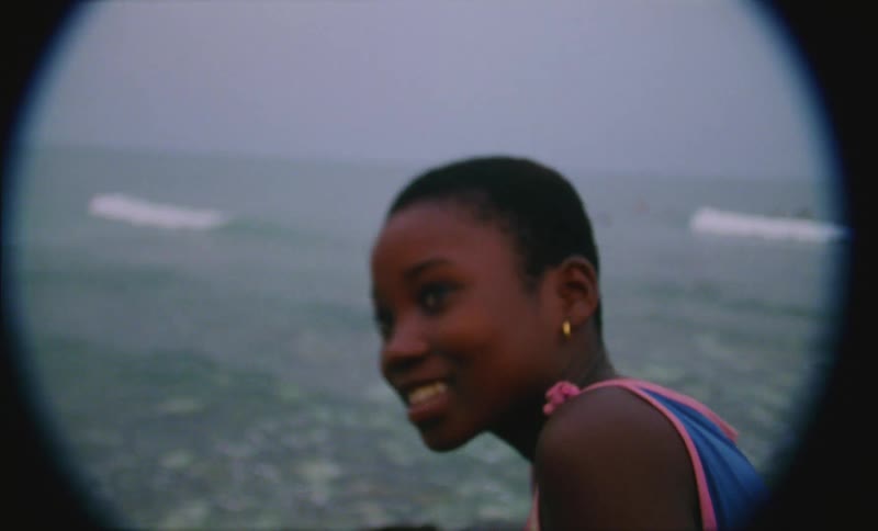 A female child is outdoors on the beach coast