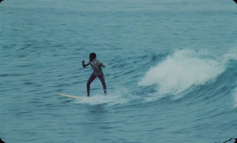 A group of people are surfing ocean waves together