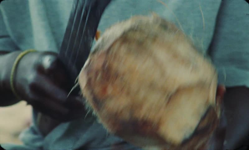 A boy is chopping a coconut on the beach