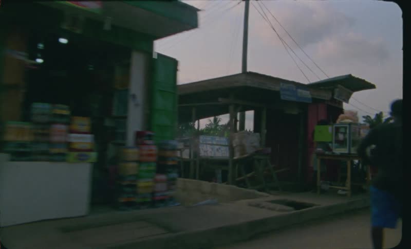 People are walking through a country at dusk