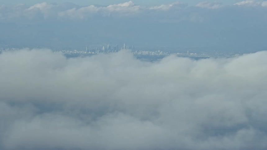 Aerial footage of downtown Los Angeles skyline seen from Catalina Island on a partly cloudy day in California