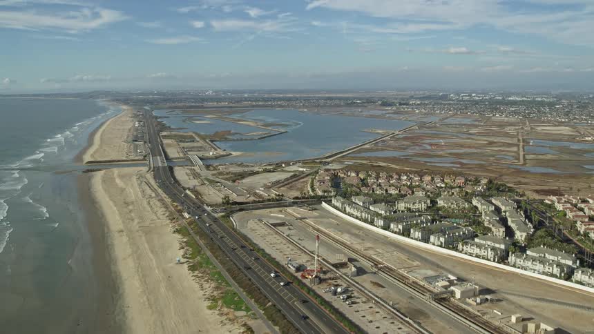 Aerial flyover of Huntington Beach showing Highway 1 beach and Bolsa Chica Basin State Marine Conservation Area