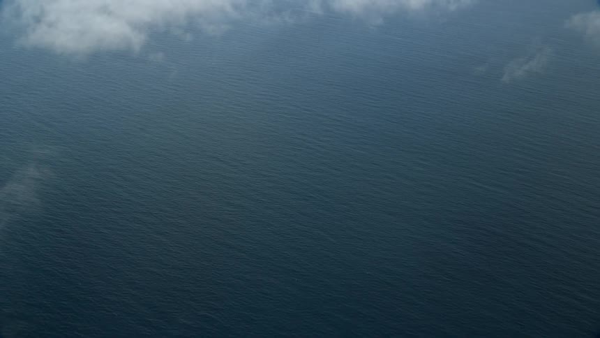 Flying above wispy clouds and the vastness of the Pacific Ocean the aerial footage captures the breathtaking beauty of the Southern California coastline during the day