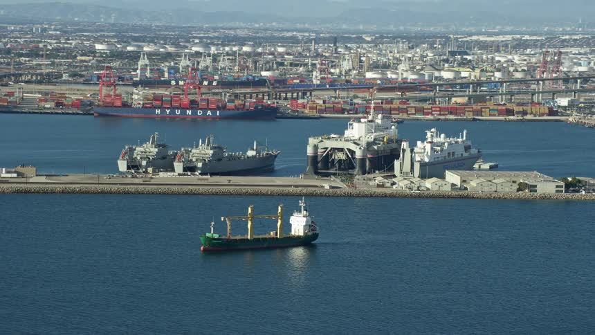 Sea Launch ship docked at the Port of Long Beach amidst other vessels and loading cranes captured in aerial footage during a partly cloudy Southern California day