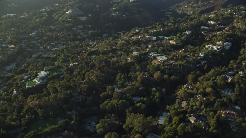 Flying over hillside mansions in sunny Beverly Hills California