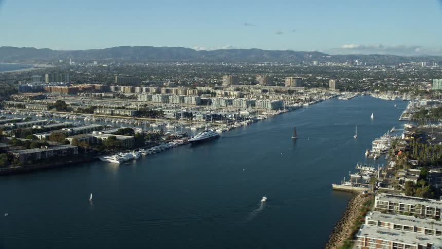 Stunning aerial view of waterfront apartment buildings and marinas in Marina Del Rey revealing Southern Californias contemporary shoreline