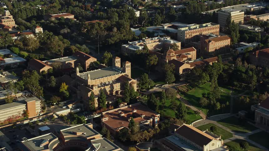 Aerial footage of Powell Library and Wilson Plaza at College Los Angeles California in vibrant sunshine during the day perfect for college and university education scene visuals