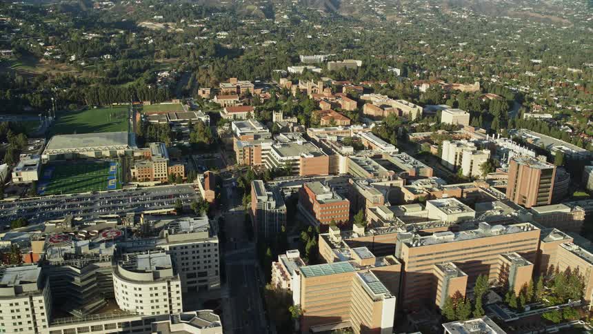 Aerial footage captures a orbit of college university campus buildings in sunny Los Angeles California